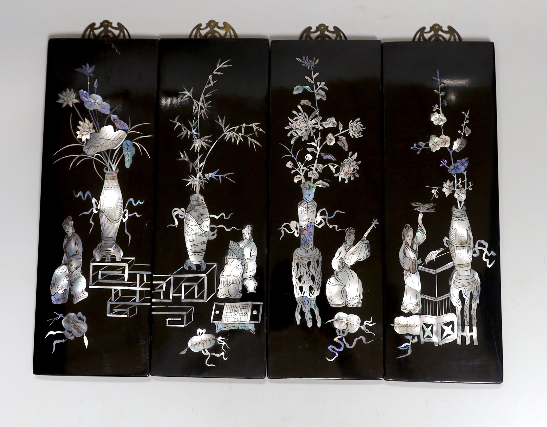 A set of four Chinese lacquer and mother-of-pearl panels, 30x10cm